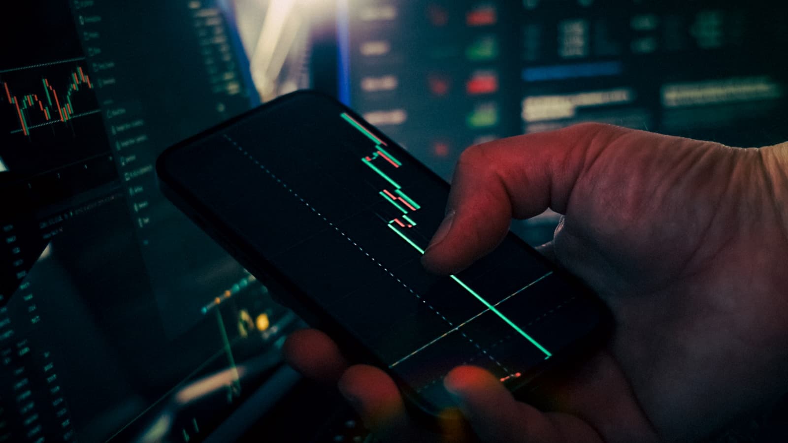 Mobile phone displaying trading chart data